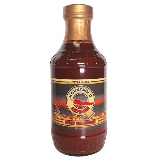 Bottle of Mountain Q Spicy Barbecue sauce with a gold cap on a white background