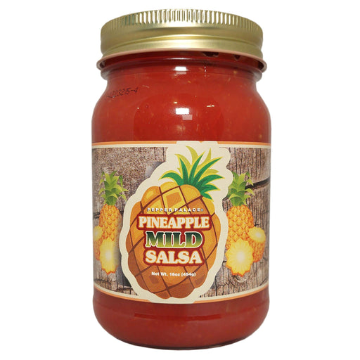 Jar of pineapple mild salsa with a gold lid on a white background