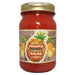 Jar of pineapple mild salsa with a gold lid on a white background