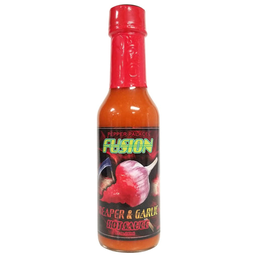 Hot sauce bottle with red cap and black label on a white background