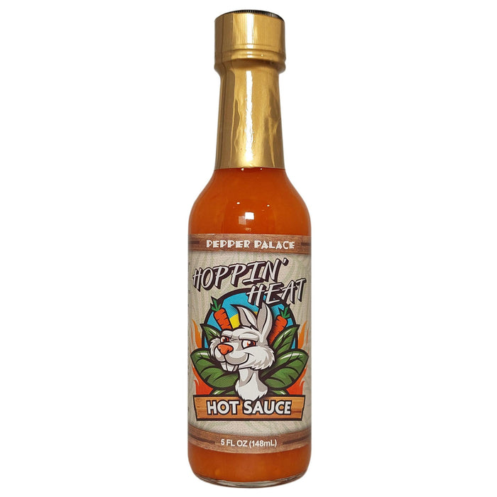 Bottle of Hoppin' Heat hot sauce with a gold cap on a white background