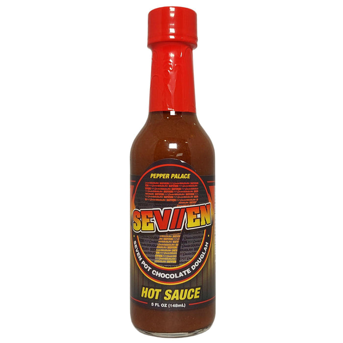 Bottle of Seven Hot Sauce with a red cap on a white background
