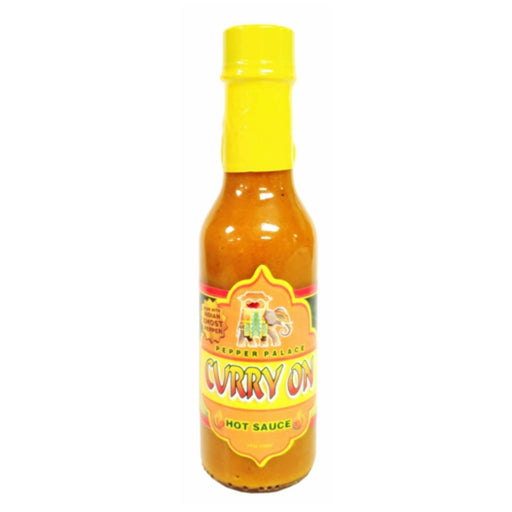 Bottle of Curry On hot sauce with a yellow cap on a white background