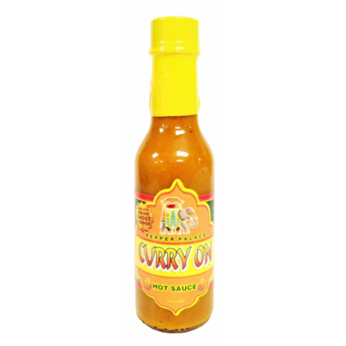 Bottle of Curry On hot sauce with a yellow cap on a white background