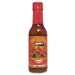 Bottle of Trs Diablos hot sauce with a red cap on a white background