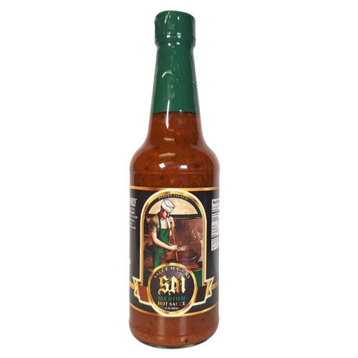 Bottle of hot sauce with a green cap on a white background