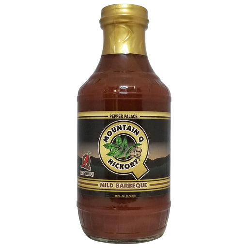 Bottle of Mountain Q Hickory Mild Barbeque sauce with a gold cap on a white background