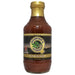 Bottle of Mountain Q Hickory Mild Barbeque sauce with a gold cap on a white background