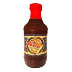 Bottle of Spicy Bourbon BBQ Sauce with a red top on a white background