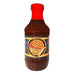Bottle of Spicy Bourbon BBQ Sauce with a red top on a white background
