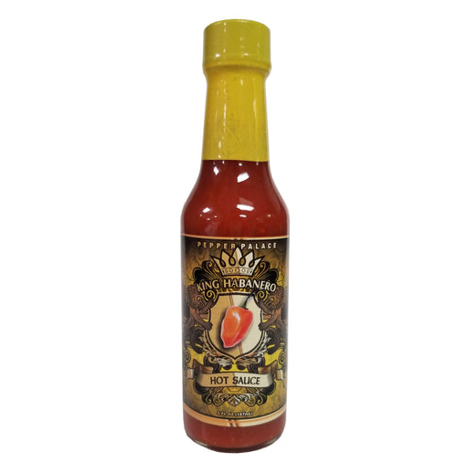 Hot sauce bottle with yellow cap and black label on a white background
