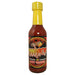 Bottle of Cinnamon Harman Hot Sauce with a yellow cap on a white background