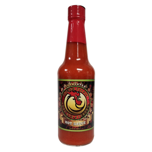 Bottle of hot sauce with a red cap on a white background