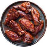 A plate of chicken wings covered in bbq sauce