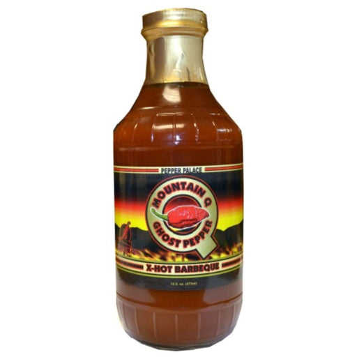 Bottle of Mountain Ghost Pepper X-Hot Barbecue Sauce with a gold cap on a white background