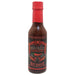 Bottle of Smoked Serrano hot sauce with a red cap on a white background