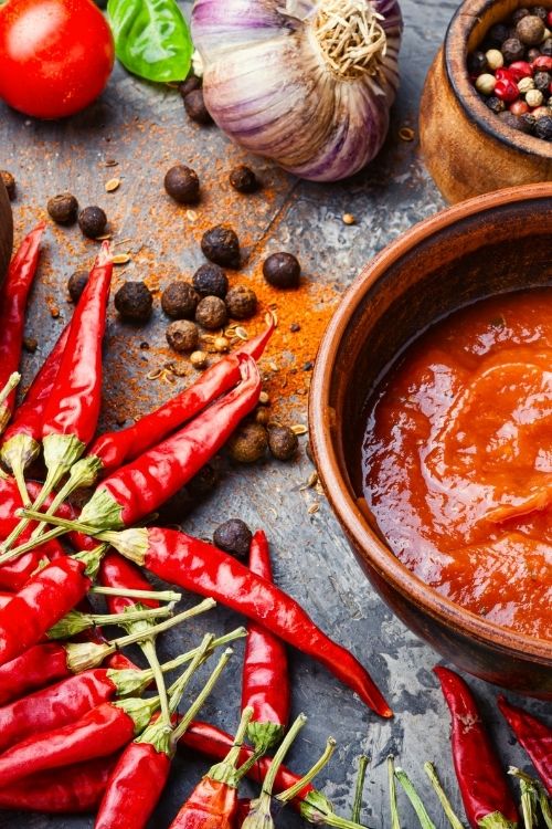 Best Sellers collection and a stone table with fresh peppers, spices, and a bowl of sauce