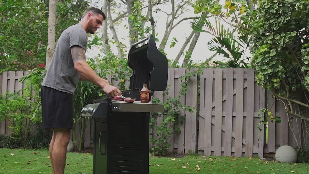 honey chipotle rum being put on grilling food