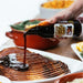 Maple Chipotle Glaze pouring onto cooked ham
