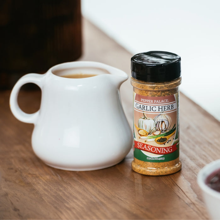 Garlic and Herb Seasoning next to a bowl of gravy